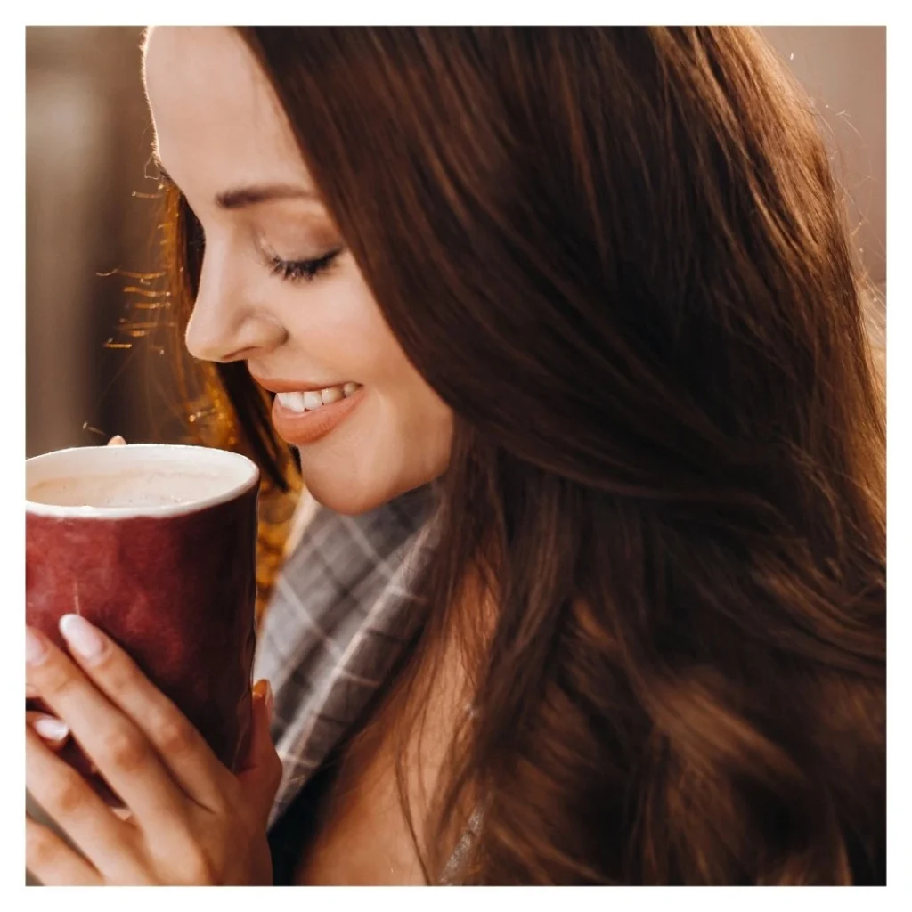 smiling woman sipping tea