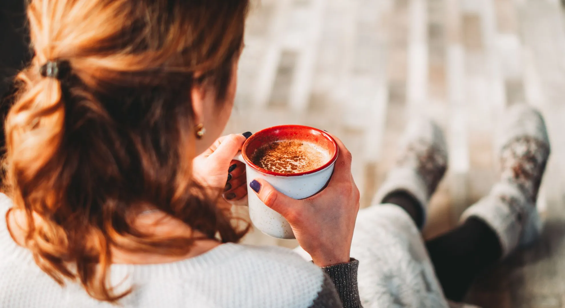 woman holding warm mug