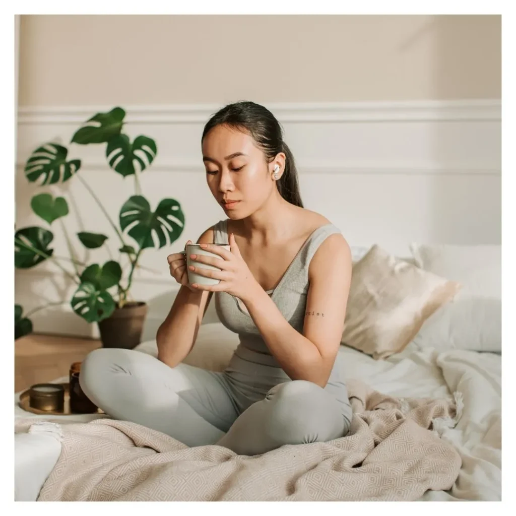 woman clutching mug meditating